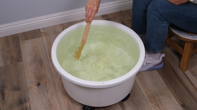 woman stiring her hydroponic reservoir woman stiring her hydroponic reservoir