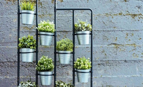 vertical garden of pots hanging in a metal frame